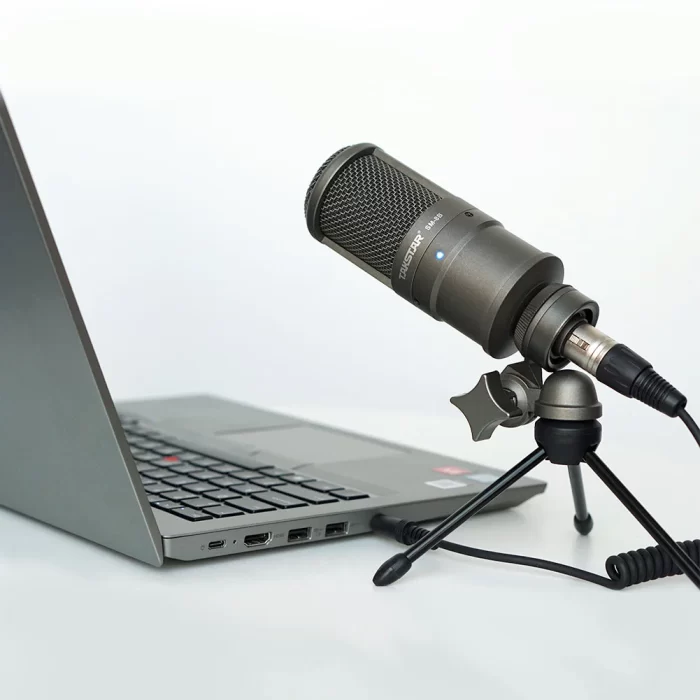 takstar sm-8b-s recording microphone on a tripod near a laptop