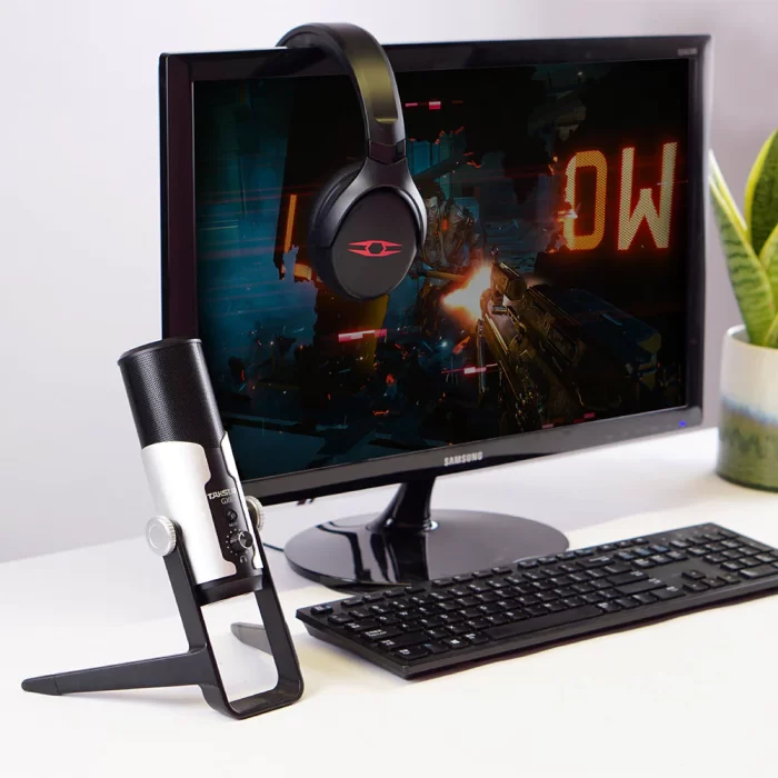 Desktop USB Condenser Microphone beside a gaming monitor